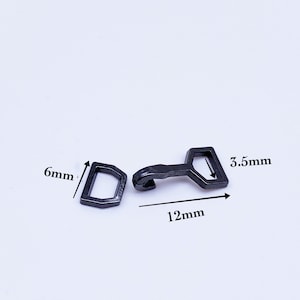 May include: Black metal clasp with a hook and a rectangular loop. The clasp measures 12 mm long, 6 mm wide, and 3.5 mm high.