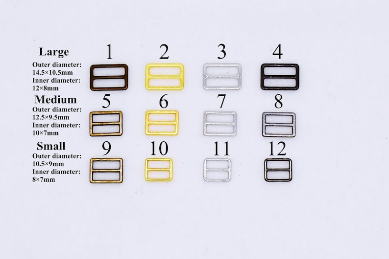 May include: Twelve metal slider buckles in three sizes: large, medium, and small. The buckles are in three finishes: antique brass, gold, and silver. The buckles are numbered 1 through 12.