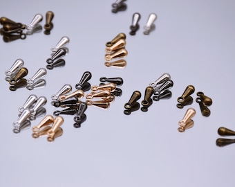 May include: Assortment of teardrop-shaped metal charms in silver, gold, and bronze finishes. The charms have a loop at the top for attaching to jewelry or other crafts.