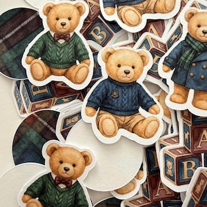 May include: A collection of stickers featuring teddy bears in various outfits, including sweaters and coats. The bears are surrounded by alphabet blocks and plaid circles, creating a vintage, nostalgic aesthetic.