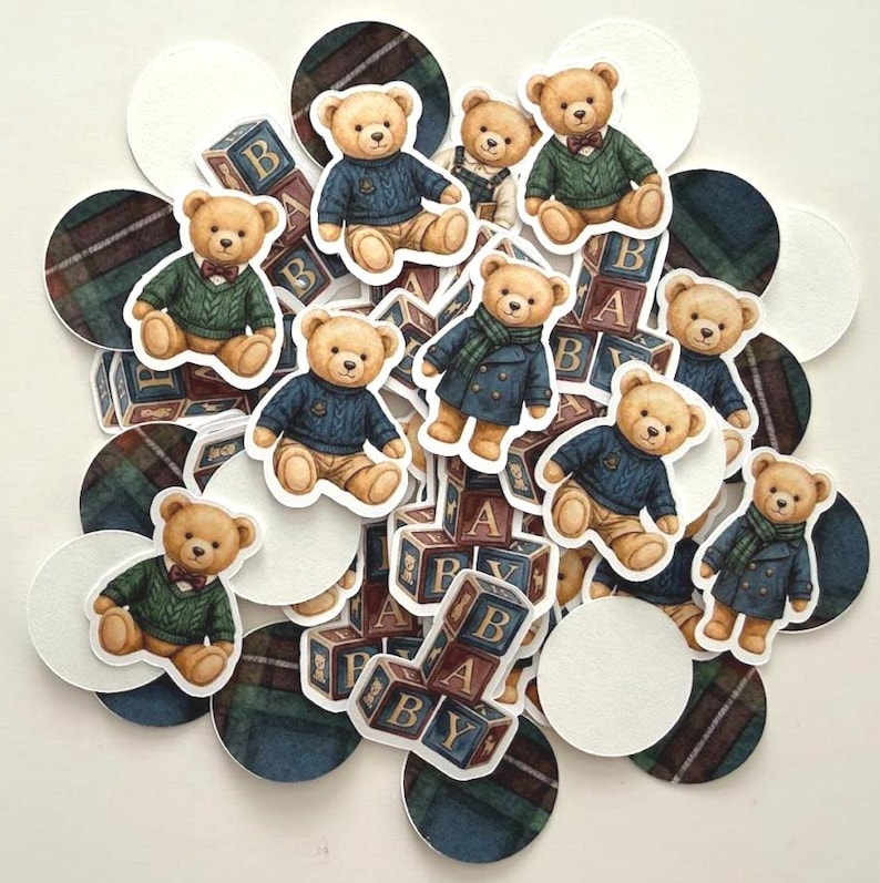 May include: A collection of teddy bear stickers and cutouts, some wearing sweaters and coats, with wooden alphabet blocks and plaid and white circles. The bears are in various poses, with some wearing bow ties and scarves.