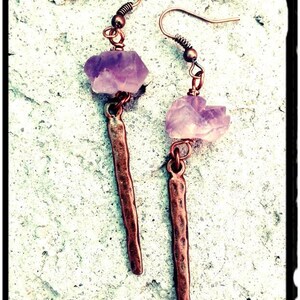 May include: A pair of earrings with amethyst stones and hammered copper dangles.