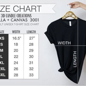 May include: A black t-shirt hanging on a gold hanger next to a size chart titled 3D CANDLE CREATIONS BELLA + CANVAS 3001 ADULT UNISEX T-SHIRT SIZE CHART. The chart lists sizes XS through 3XL with corresponding width and length in inches.