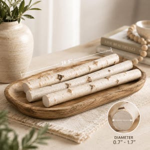 May include: Four birch logs, each with a diameter between 0.7 and 1.7 inches, are displayed in a wooden tray. The tray is approximately 16.5 inches long. The logs have a natural, light-colored bark with visible knots, perfect for rustic decor.
