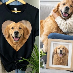 May include: A black short-sleeved t-shirt featuring a large heart-shaped graphic of a golden retriever dog with its mouth open. The design shows the dog's face and chest in a realistic photographic style centred on the front of the garment.
