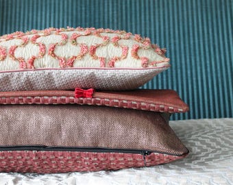 Hand made cushion in upholstery fabric with double-sided design.