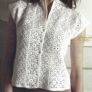 May include: White crochet top with a button-up front and short sleeves. The top has a delicate openwork pattern.