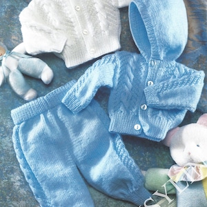 May include: A knitted baby outfit set in blue and white. The set includes a hooded cardigan, a button-up cardigan, and pants. The cardigan has a cable knit pattern.