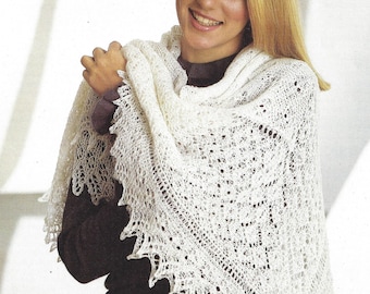 May include: A white lace shawl with a delicate pattern. The shawl is draped around a person's shoulders and neck.