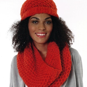 May include: A bright orange knitted hat and matching infinity scarf. The hat has a simple design with a wide brim. The scarf is thick and cozy.