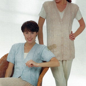 May include: Two women wearing knitted vests with short sleeves. The vest on the left is light blue and the vest on the right is beige. Both vests have a V-neck and button closure.