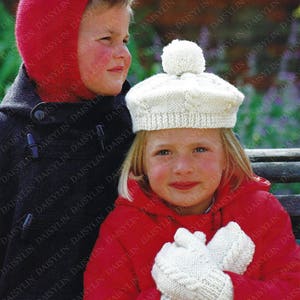 May include: Two children wearing knitted hats and mittens. The girl is wearing a white hat with a pompom and a red jacket. The boy is wearing a red hat and a navy blue jacket. Both children are wearing white knitted mittens.
