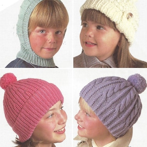 May include: Four children wearing different knitted hats. The hats are in various colors, including pink, white, purple, and green. Some of the hats have pom-poms on top.