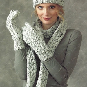 May include: A white and gray knitted hat, scarf, and gloves set. The hat has a cable knit pattern and the scarf and gloves have a textured knit pattern.