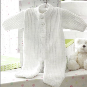 May include: White knitted baby onesie with a button closure. The onesie has a ribbed texture and is hanging on a hanger.