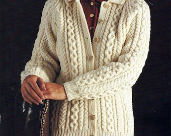 May include: A cream-colored knitted cardigan with a cable knit pattern and button closure.