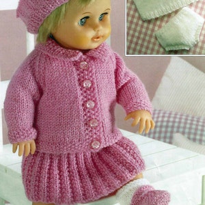 May include: A pink knitted doll outfit with a matching hat, cardigan, skirt, and booties. The outfit is decorated with pearl-like buttons.