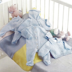 May include: Three knitted baby outfits in light blue. One is a hooded cardigan, one is a cardigan with a collar, and one is a one-piece jumpsuit.
