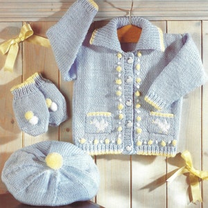 May include: A light blue knitted baby cardigan with yellow trim, white buttons, and embroidered flowers. The set also includes a matching hat and mittens.