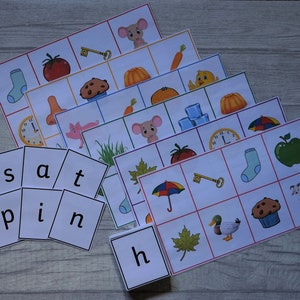May include: A set of educational flashcards with colourful illustrations of objects and animals, plus letter cards spelling words. The cards feature images of a tomato, key, mouse, and more, designed for early learning and literacy.
