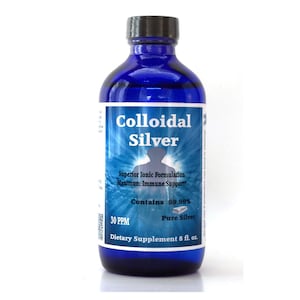 May include: A blue glass bottle with a black cap containing colloidal silver dietary supplement. The label reads "Colloidal Silver", "Superior Ionic Formulation", "Maximum Immune Support", "Contains 99.99% Pure Silver", "30 PPM", and "Dietary Supplement 8 fl. oz."