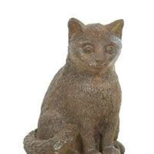 May include: A brown ceramic cat figurine sitting on a white background. The cat has a realistic appearance with a textured surface.