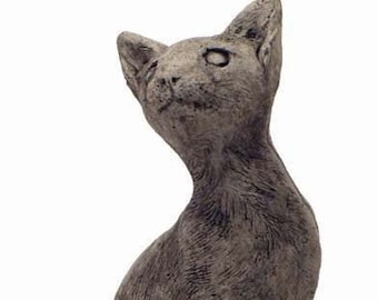 May include: A gray concrete cat statue sitting on a stone base. The cat is looking up and has a detailed, realistic design.