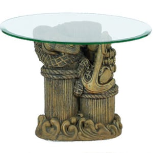 May include: A glass-top end table with a nautical theme. The base is made of resin and features a sculpted design of a ship's anchor and rope.
