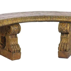 May include: A curved, gold-painted concrete bench with ornate lion's paw feet. The bench has a decorative, textured top.