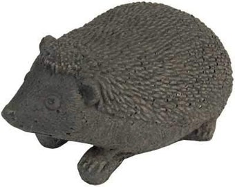 May include: A gray concrete garden sculpture of a hedgehog. The sculpture is detailed with textured fur and a realistic face.