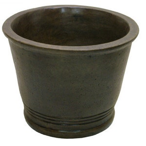 May include: A dark gray ceramic planter with a rounded bottom and a slightly flared rim. The planter has a textured surface and a subtle lip around the top.