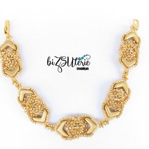 May include: Gold beaded bracelet with a geometric design. The bracelet is made with small gold beads and features a repeating pattern of interlocking triangles.