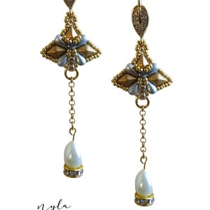 May include: Gold and silver beaded earrings with a pearl drop. The earrings are designed in a geometric shape and have a leaf-shaped hook.