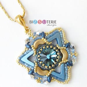 May include: A gold chain necklace with a blue and gold star-shaped pendant. The pendant features a large blue crystal in the centre and is surrounded by smaller gold and blue beads. The pendant is labelled "Bizsuterie design".