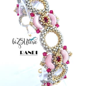 May include: A silver and gold beaded bracelet with pink and red beads. The bracelet is made with a variety of beads, including small round beads, larger oval beads, and small crystal beads. The bracelet is designed in a circular pattern with a repeating motif of pink and red beads.