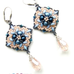 May include: A pair of dangle earrings with a hexagonal design featuring blue and pink beads. The earrings have a teardrop-shaped crystal pendant.
