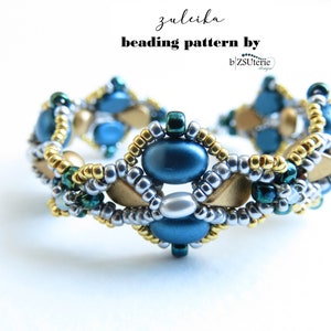 May include: A beaded bracelet with a geometric design featuring blue, gold, silver, and green beads. The bracelet is called "zuleika" and the beading pattern is by b'zSuterie.