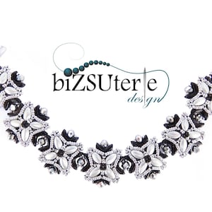May include: A black and white beaded bracelet with a floral design. The bracelet is made with small, round beads and features a repeating pattern of flowers. The bracelet is accented with black beads and silver beads.