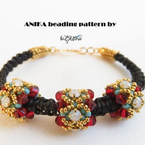 May include: A beaded bracelet with a black cord and gold-colored accents. The bracelet features three clusters of red, gold, and turquoise beads, with a central white bead in each cluster. The text "ANIKA beading pattern by bizZtlerie" is at the top.