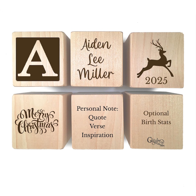 May include: Six light-colored wooden blocks arranged in two rows. The blocks feature dark brown engravings including the letter A, the name Aiden Lee Miller, a leaping deer with the year 2025, the text Merry Christmas, Personal Note, and Birth Stats.