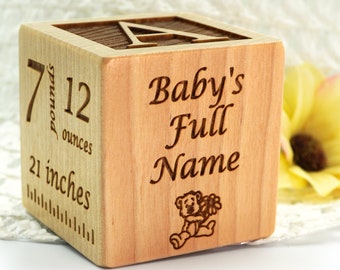 May include: A wooden block with a teddy bear design and the text "Baby's Full Name". The block also has a ruler on one side with measurements in inches and ounces. The block is 7 pounds and 12 ounces.
