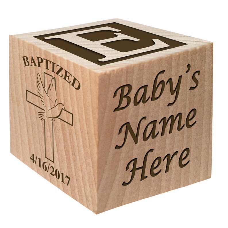 May include: Wooden block with the letter "B" on one side and the words "Baptized", "Baby's Name Here", and "4/16/2017" on another side. The block also features a dove and cross design.