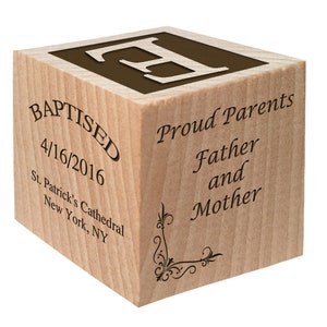 May include: A wooden block with the letter "F" on one side and the text "Baptised 4/16/2016 St. Patrick's Cathedral New York, NY" on another side. The opposite side has the text "Proud Parents Father and Mother".