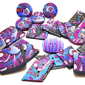 May include: A collection of assorted buttons in various shapes including round, square, and rectangular. Each button features a vibrant, multi-colored abstract pattern in shades of bright blue, deep purple, magenta, and black with distinct line work.