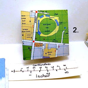 May include: A map of North Sydney, Australia, showing the location of the North Sydney Oval, a sports field. The map is printed on a piece of paper and is approximately 3 inches wide.