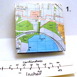 May include: A map of a small area with a blue body of water labeled "Lavender Bay What" and a green park labeled "Quibarne Park". The map is printed on a white background with black lines and text. The map is approximately 3 inches wide.