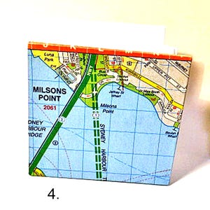 May include: A map of Milson's Point, a suburb of Sydney, Australia. The map shows the location of Milson's Point, Sydney Harbour Bridge, and Luna Park. The map is printed on a blue background with green, yellow, and red lines.