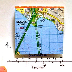 May include: A close-up of a map of Milsons Point, Sydney, Australia. The map shows the location of the Sydney Harbour Bridge, the Sydney Harbour Tunnel, and other landmarks. The map is printed on a white background with blue and green lines.