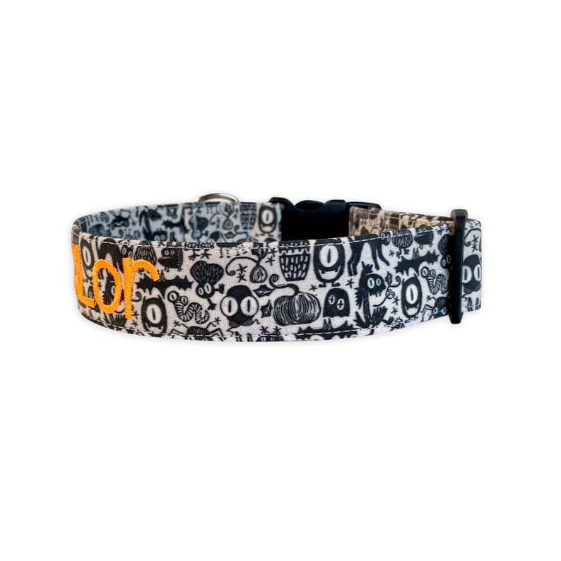 Celebrate spooky season in style with this Halloween ghost collar from Duke & Fox®. Featuring a playful black and white ghost print with vibrant orange embroidery, it perfectly blends festive fun and everyday wear. Each collar is handcrafted from durable cotton with high-quality hardware for lasting comfort and charm. Add custom embroidery to make it uniquely yours — a bold, seasonal accessory handmade in Tennessee.
