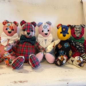 May include: Four handmade teddy bears with unique fabric patterns. One bear has a floral pattern, another a red plaid, a third a pink and white gingham, and the last two have a Harry Potter theme. Each bear has a white bow tie.